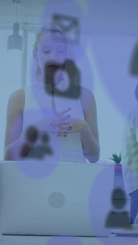 Vertical video: Host looking at laptop then gesturing, purple UI and phone Stock Footage 334540440