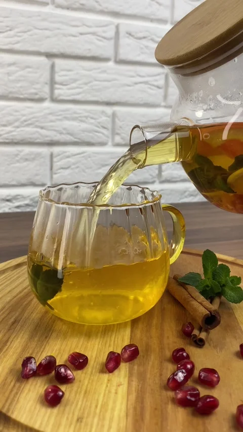 Vertical video: Hot herbal tea with red crandberries poured into glass cup from Stock Footage 266149442