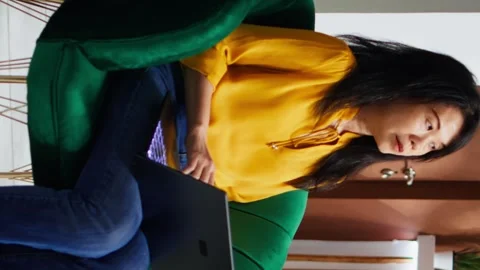 Vertical Video Hotel guest working on laptop in lounge area lobby Video stock 261336978