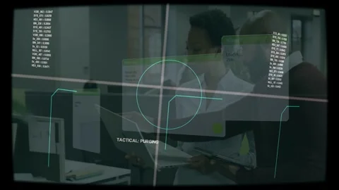 Vertical video: HUD appearing two staff checking monitor tablet data at desk in Stock Footage 333004699