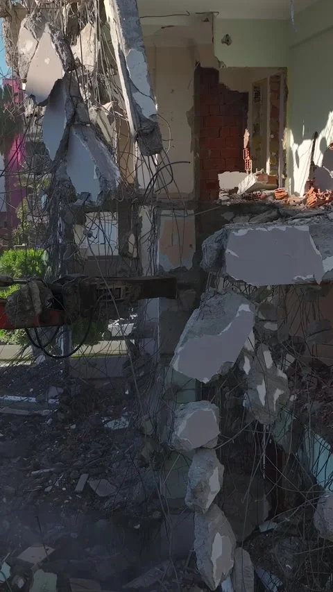 Vertical Video: A hydraulic excavator systematically demolishes an outdated Video stock 297630992