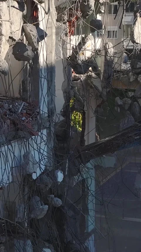 Vertical Video: The hydraulic hammer of an excavator demolishes concrete walls Stock Footage 297631153