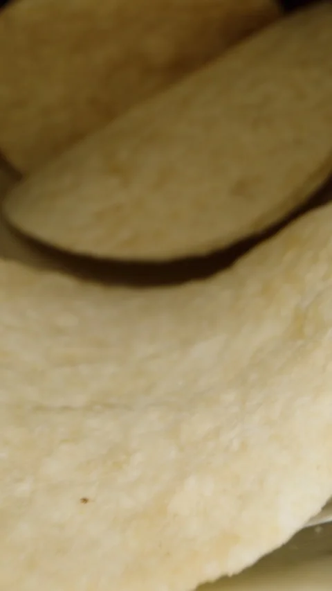 Vertical video. I pour a stack of corn chips from a long can onto the table. Bla Stock Footage 260933990