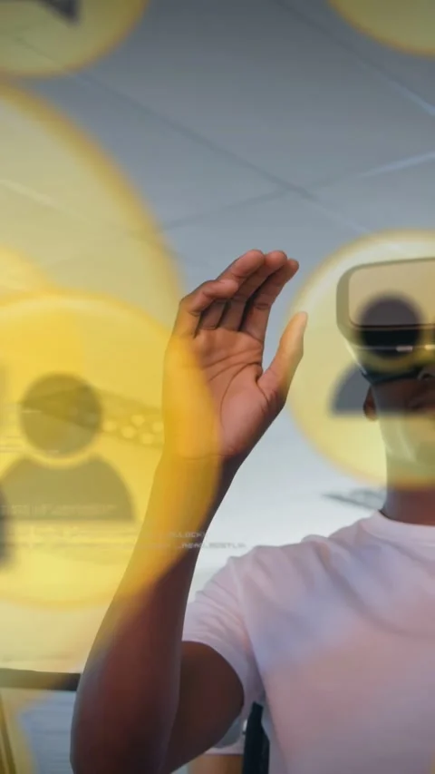 Vertical video: As icons focus, dev in VR headset raising hand pinching yellow Stock Footage 333577656