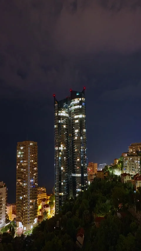 Vertical video. Illuminated skyscraper in residential city at night, Monte Carlo Stock Footage 308409666