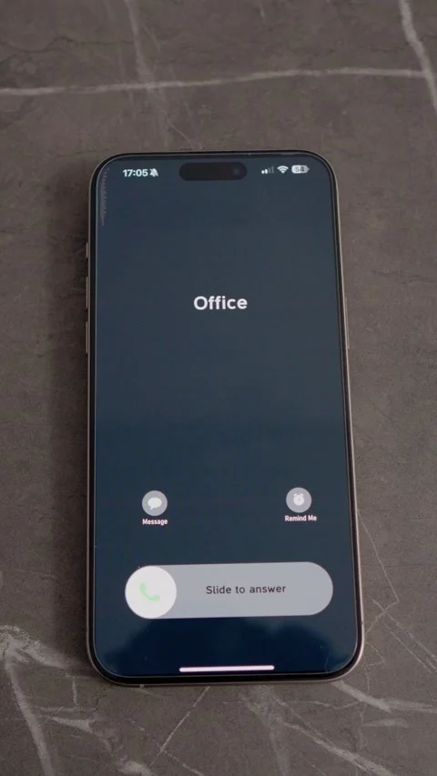 Vertical video Incoming call from office shown on smartphone on a table Stock Footage 346715385