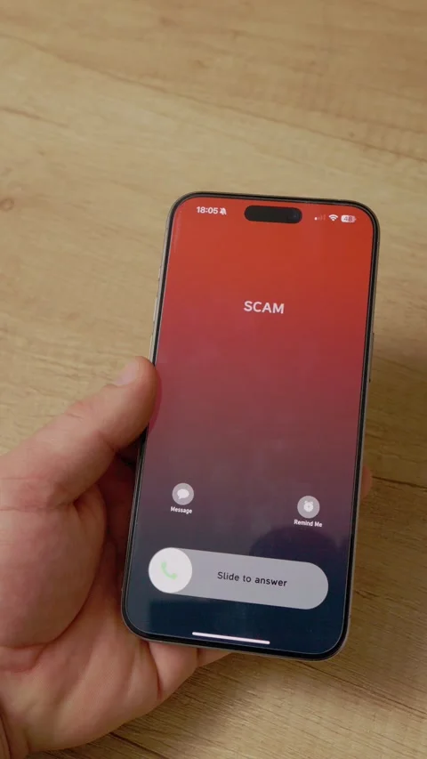 Vertical video Incoming scam call on smartphone captured on wooden table closeup Stock Footage 346716325