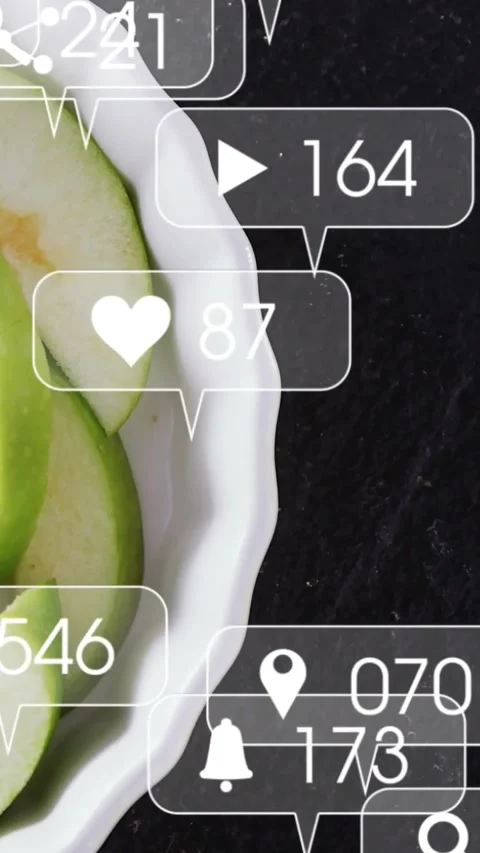 Vertical video: Incoming social bubbles animating hearts over dish with apple Stock Footage 331738902