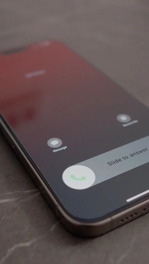 Vertical video Incoming spam call shows up on smartphone in macro shot on table Stock Footage 346715676