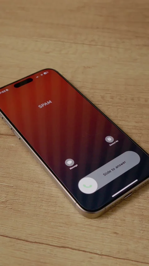 Vertical video Incoming spam call on smartphone detected on wooden table surface Stock Footage 346716171