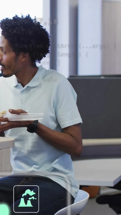Vertical video: Inspecting man in polo holding to-go box on stool in office as Stock Footage 334318827