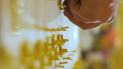 Vertical video. Installing ceramic floor tiles measuring and cutting the pieces Video stock 220104998