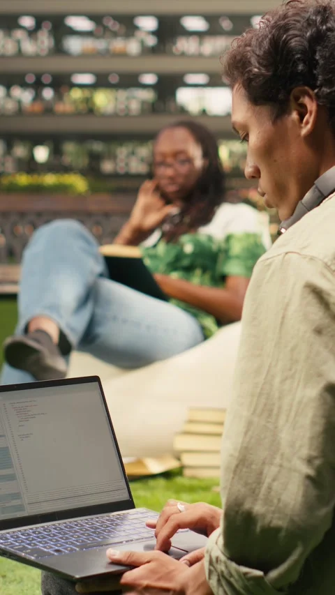 Vertical Video International student using laptop with coding content on campus Stock Footage 341321170