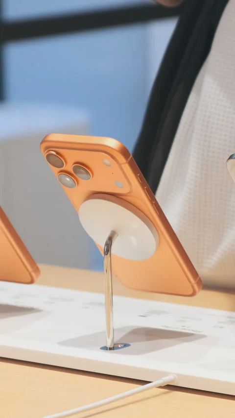 Vertical video: iPhone 17 smartphone on display inside Apple Store. Bright new Stock Footage 322514730