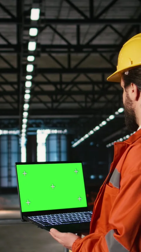 Vertical Video Isolated chroma key, laptop screen, engineer in machinery hall Stock Footage 330085491