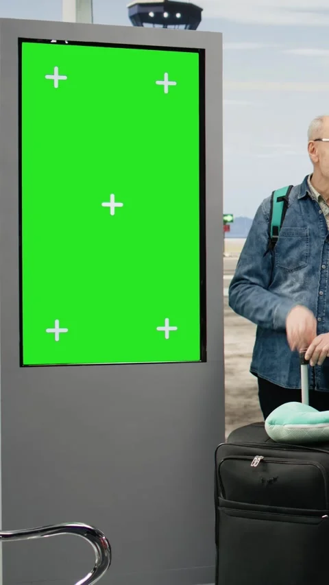 Vertical Video Isolated chroma key on departure screen elderly couple traveling Stock Footage 344373474