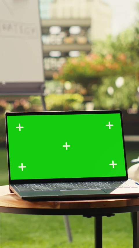 Vertical Video Isolated green screen on laptop in sunlit office terrace with no Stock Footage 339069753