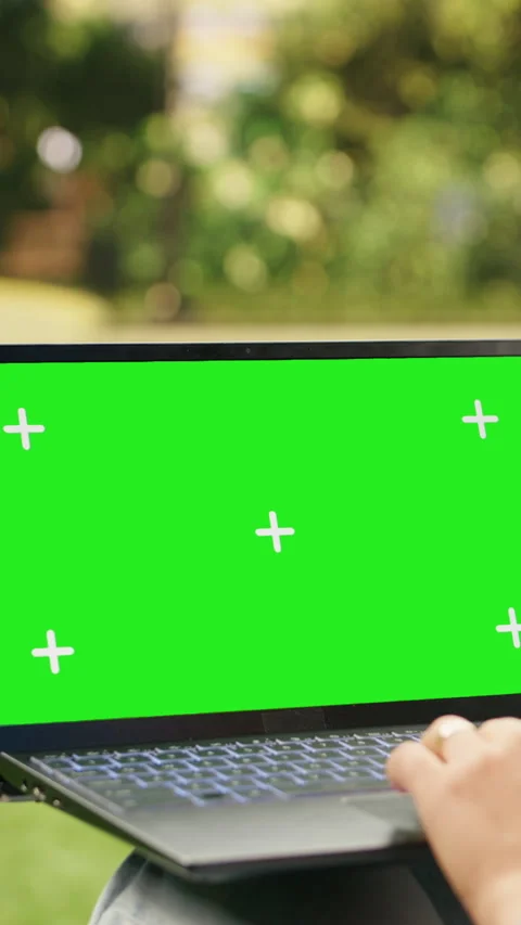 Vertical Video Isolated green screen mockup on laptop held by casual woman in Stock Footage 344380219