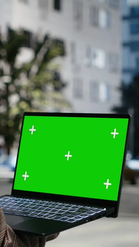 Vertical video Isolated screen laptop held by businesswoman on city boulevard Stock Footage 343560084