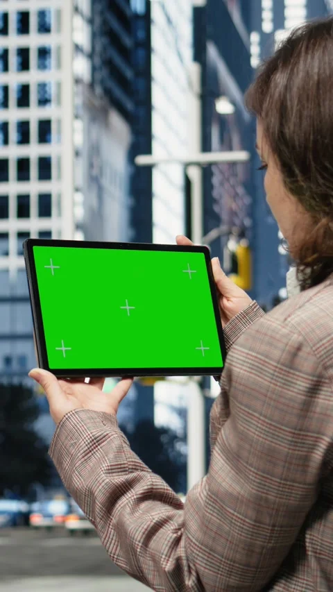 Vertical video Isolated screen tablet used by businesswoman in urban city Stock Footage 343558261
