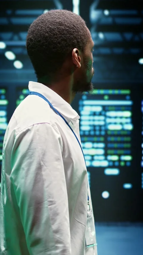 Vertical video IT admin walking in server farm Stock Footage 245914862