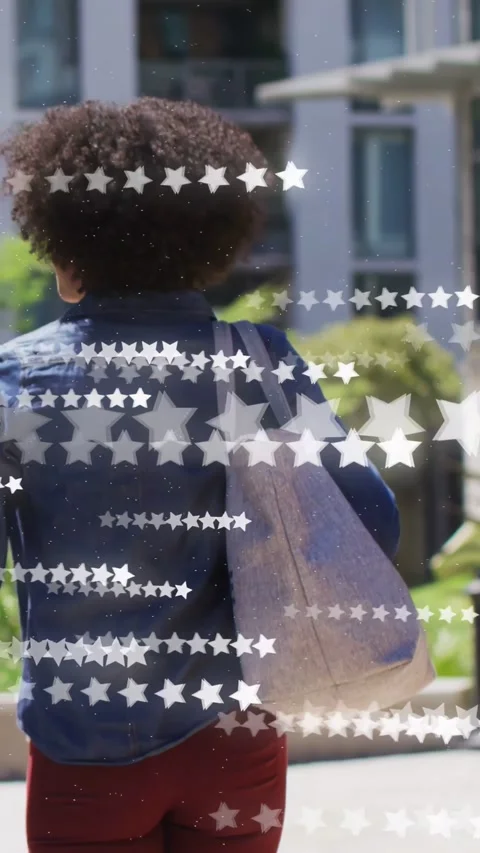 Vertical video: IT cam pulling back, woman walking yard with tote while stars Video stock 332644845