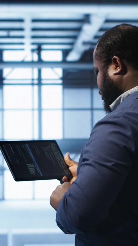 Vertical video IT expert in server hub facility looking for network bugs with Stock Footage 277854613