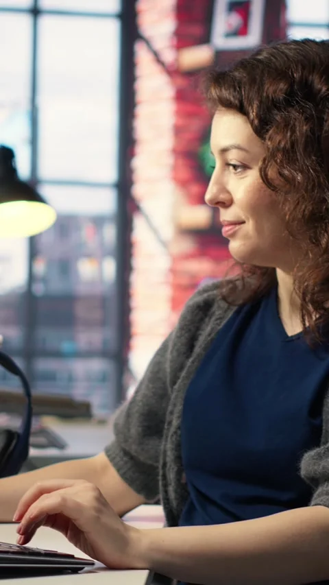 Vertical Video IT female technician uses coding language on computer at the Stock Footage 308491925