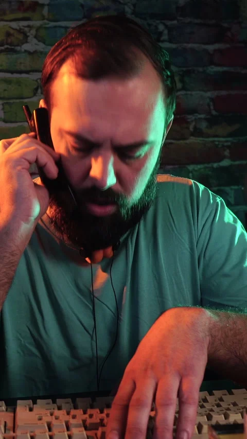 Vertical Video, IT Guy From 1990's Answering Phone Call on Flip Mobile Phone in Stock Footage 303008829