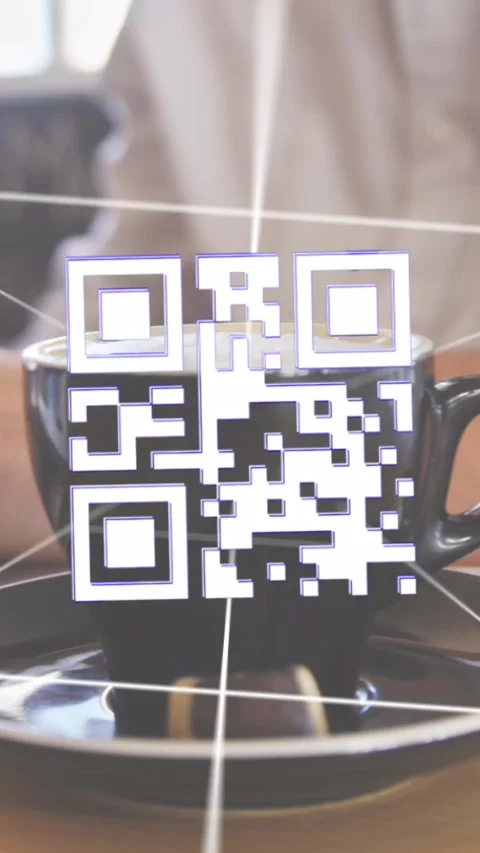 Vertical video: IT man typing, thin lines sparking 3D QR over cup, landing near Stock Footage 326668764