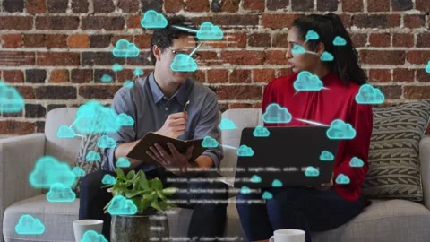 Vertical video: IT pair reading project docs sofa sending blue cloud code Stock Footage 332686334