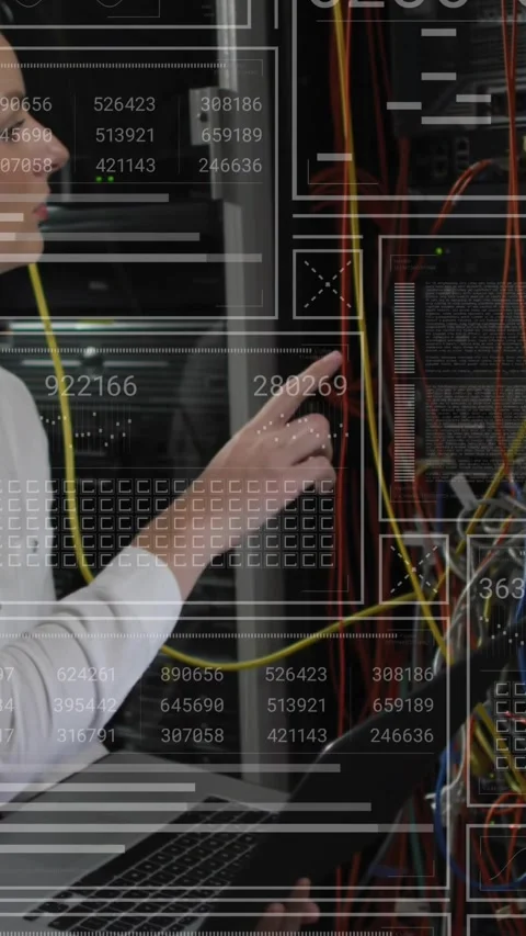 Vertical video: IT pro holding yellow cable above laptop testing patch panel Stock Footage 331337092