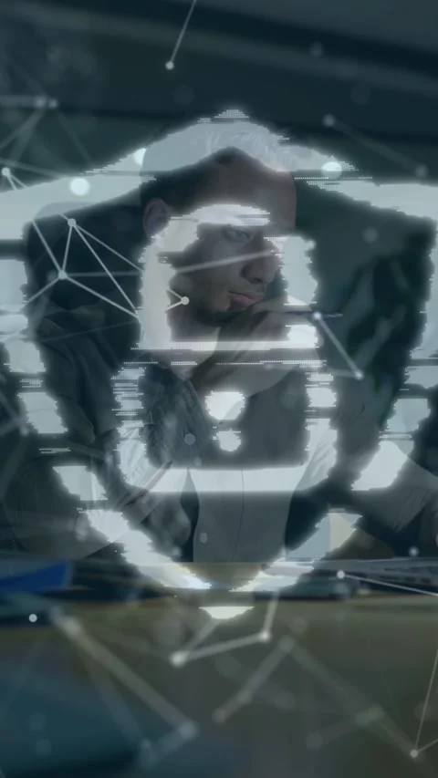 Vertical video: IT pro leaning tapping pen as code streams form shield Stock-Footage 335355439