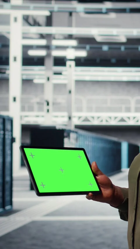 Vertical video IT professional in data center using green screen tablet Stock Footage 317053965