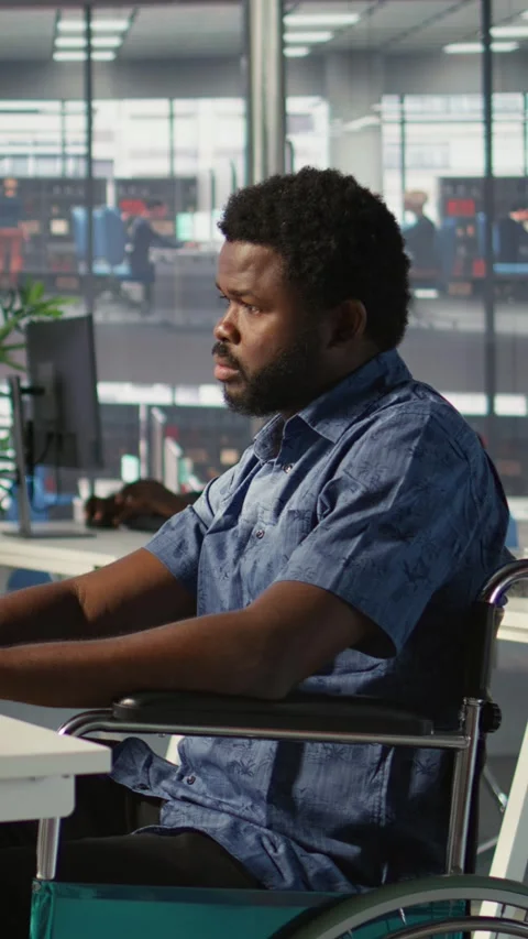 Vertical video IT professional with disability in wheelchair optimizing code Stock Footage 319491397