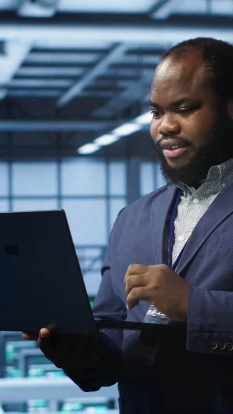 Vertical video IT professional in server room looking for network issues Stock Footage 277855532