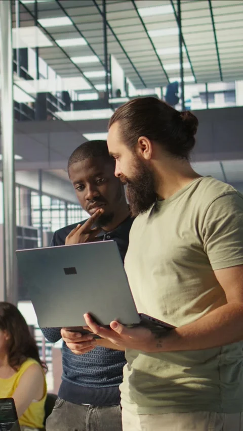 Vertical video IT staff members in office analyzing and interpreting complex Stock Footage 319484452