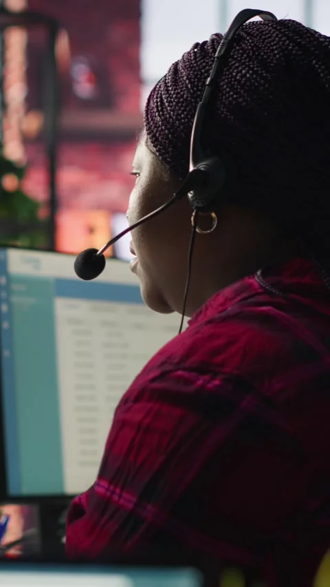 Vertical video IT support specialist at PC in office helping customers during Stock Footage 306049162