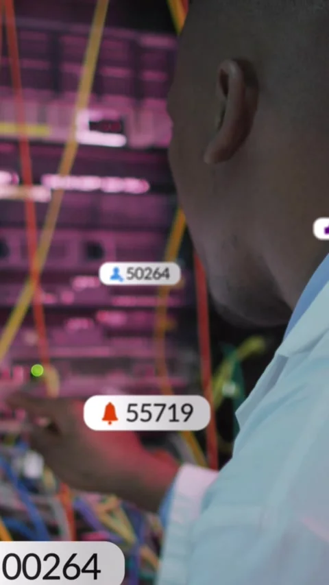Vertical video: IT tech noticing overlays with changing counts, adjusting cables Stock Footage 334397534