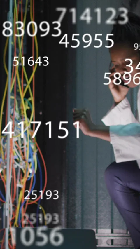 Vertical video: IT tech reaching rack, adjusting cables, checking laptop while Video stock 331274027