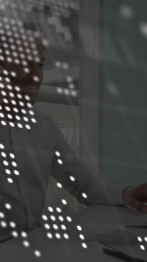 Vertical video: IT tech speaking on headset mousing while dot map and code Stock Footage 333020851