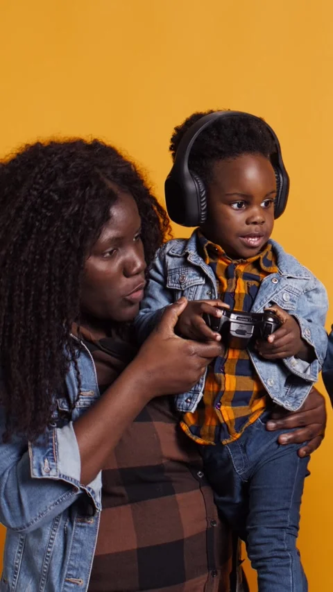 Vertical Video Joyful optimistic dad playing online video games with his boy Video stock 323537164