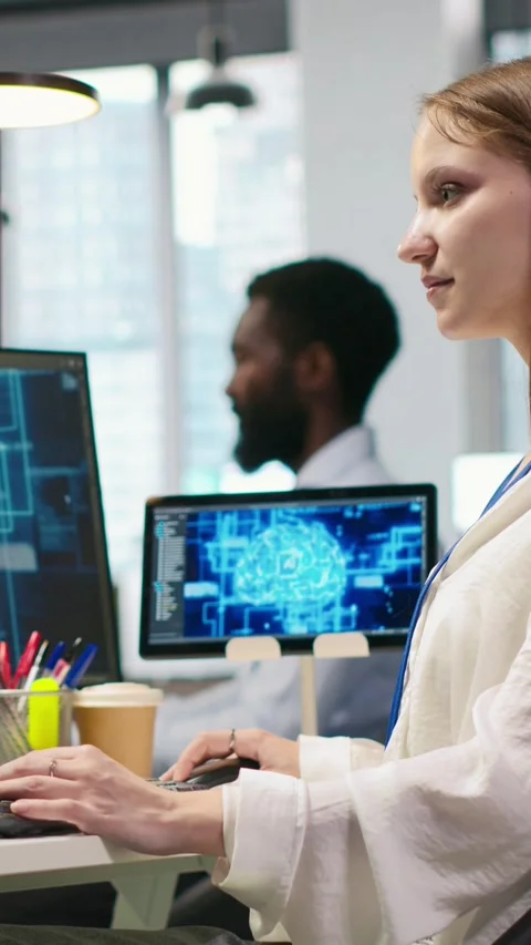 Vertical video Junior developer in office streamline workflows using AI systems Stock Footage 312768896
