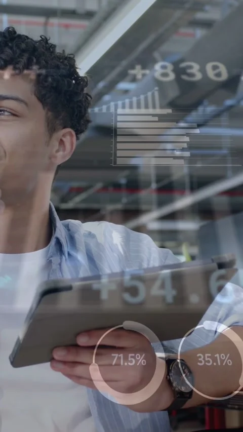 Vertical video: Junior pro tapping tablet in office, checking data while Stock Footage 335513735