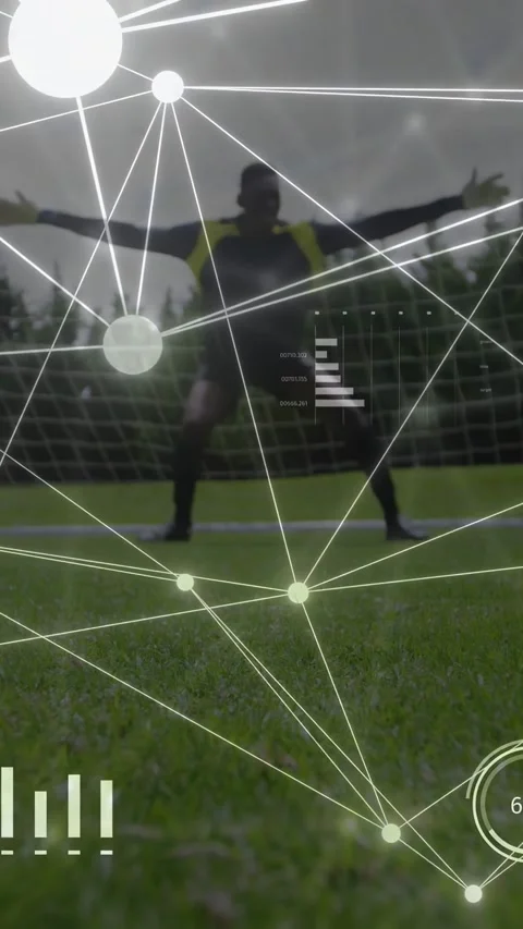 Vertical video: Keeper lunging to stop shot after striker sliding in, sports HUD Stock Footage 333862286