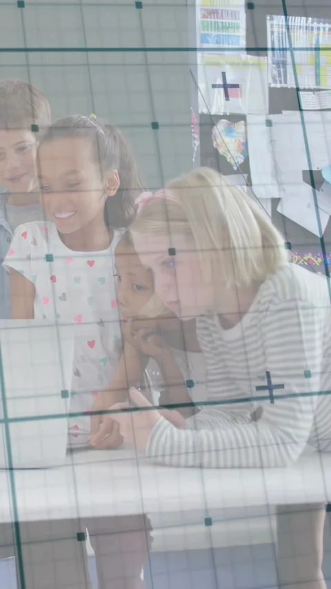 Vertical video: Kids leaning over laptop in class, child typing keys starting Stock Footage 331238093