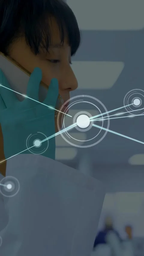 Vertical video: Lab tech answering phone in lab, HUD linking phone with Stock Footage 334186956