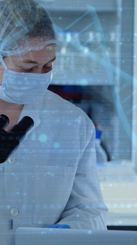 Vertical video: Lab tech glancing aside leaning at microscope testing samples Stock Footage 330510000