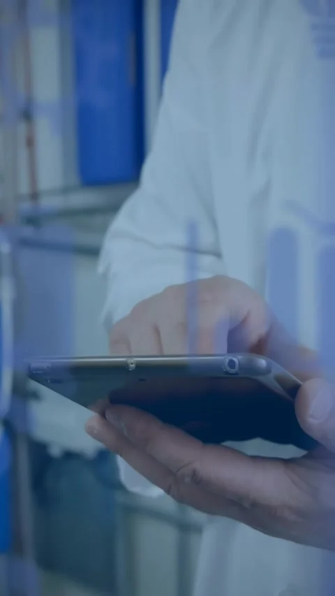 Vertical video: Lab tech tapping tablet in lab, creating blue overlays revealing Stock Footage 330965605