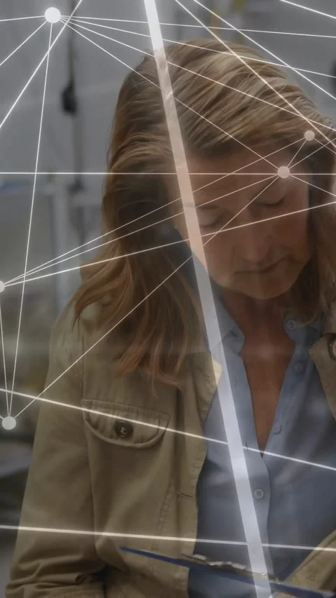 Vertical video: Lab technician inspecting tool, node overlay crossing torso Stock Footage 333977928